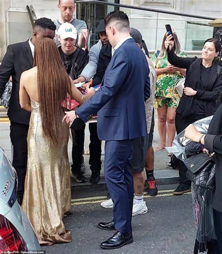 Signing autographs: Her tresses were styled in stunning long braids that cascaded down her back, while she completed her look with gold bangles around her upper arms